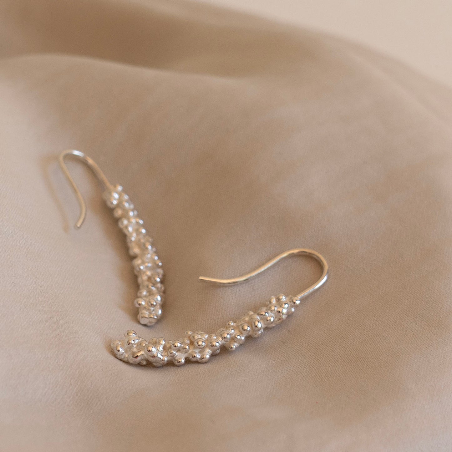 Silver millet stick drop earrings