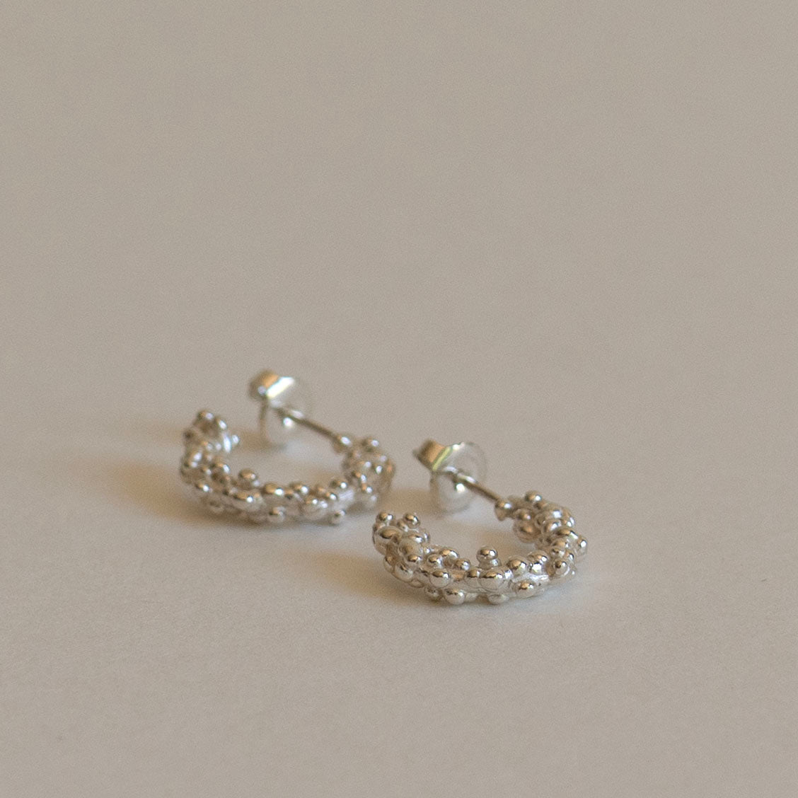 Silver millet seed hoop earrings