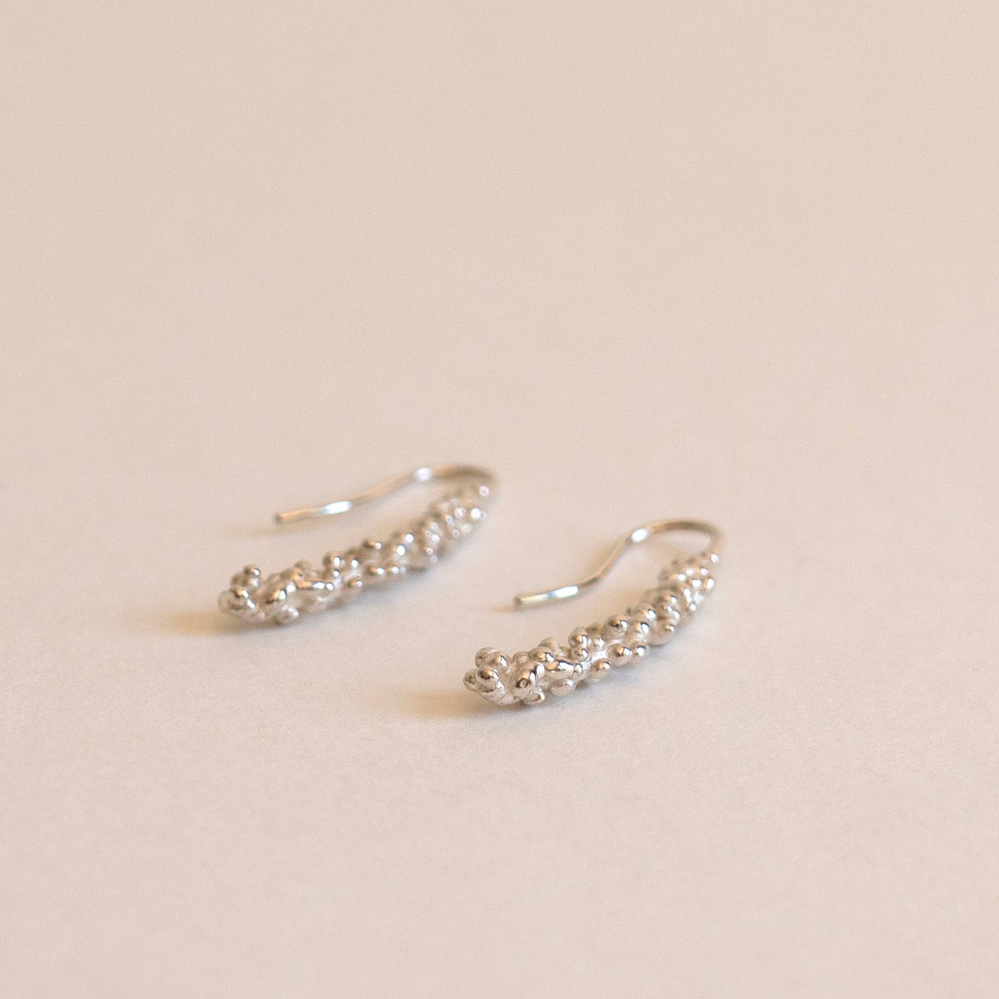 Silver millet stick drop earrings