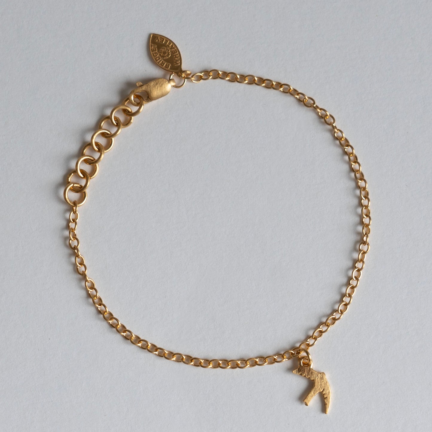 Gold swift charm bracelet