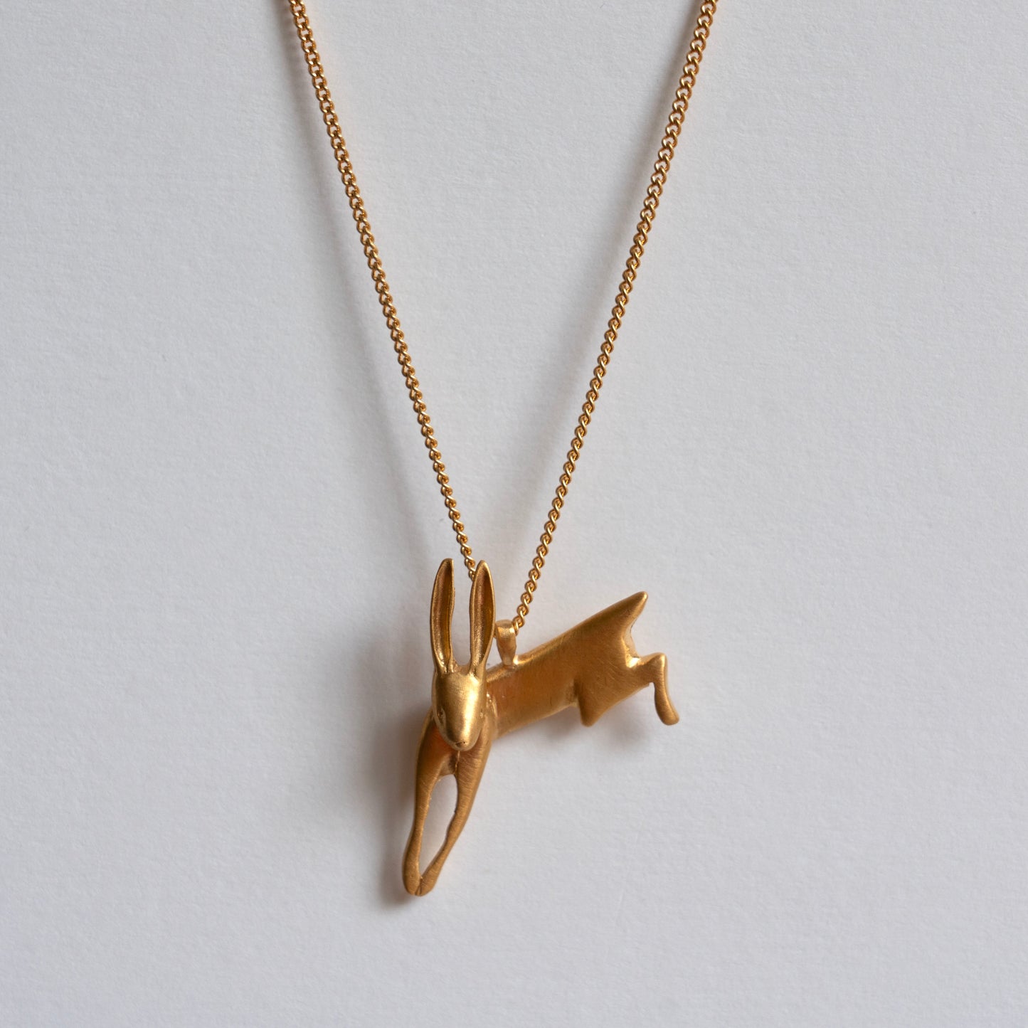 Gold leaping hare necklace