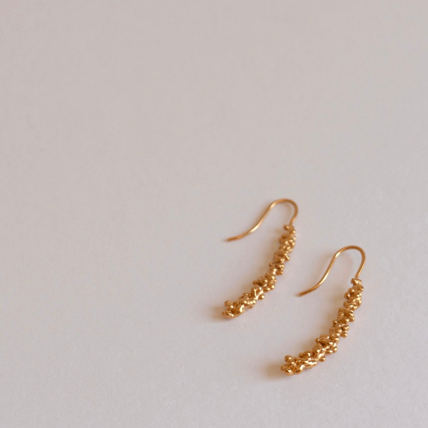 Gold millet stick drop earrings