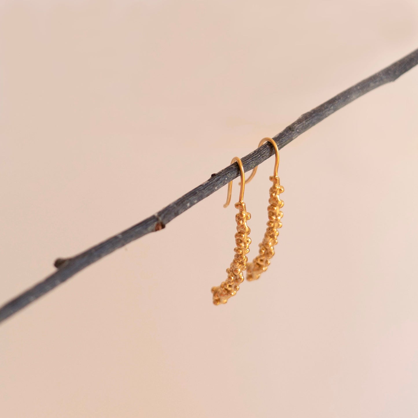 Gold millet stick drop earrings