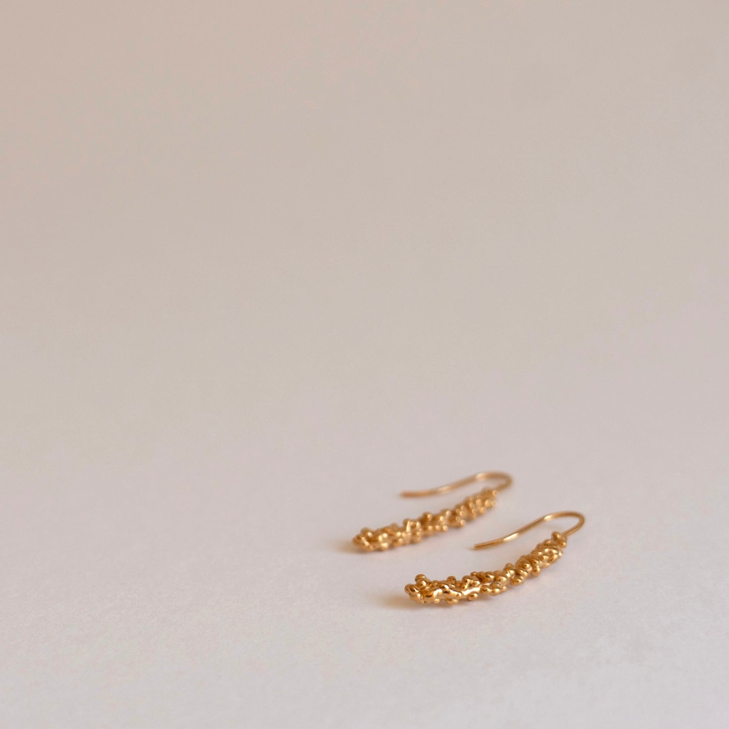 Gold millet stick drop earrings