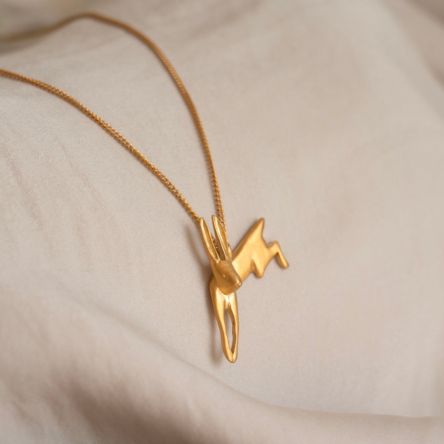 Gold leaping hare necklace