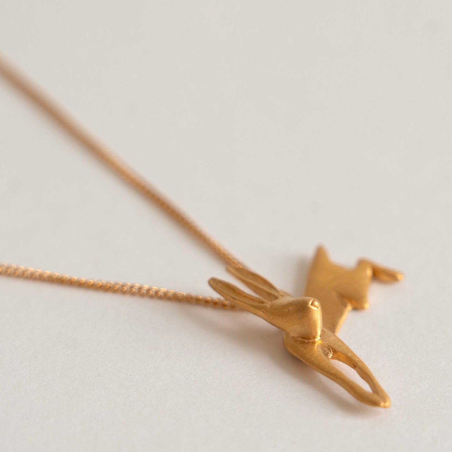 Gold leaping hare necklace