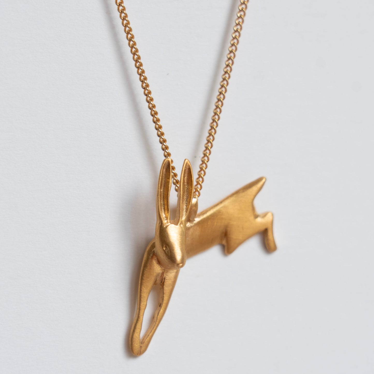 Gold leaping hare necklace