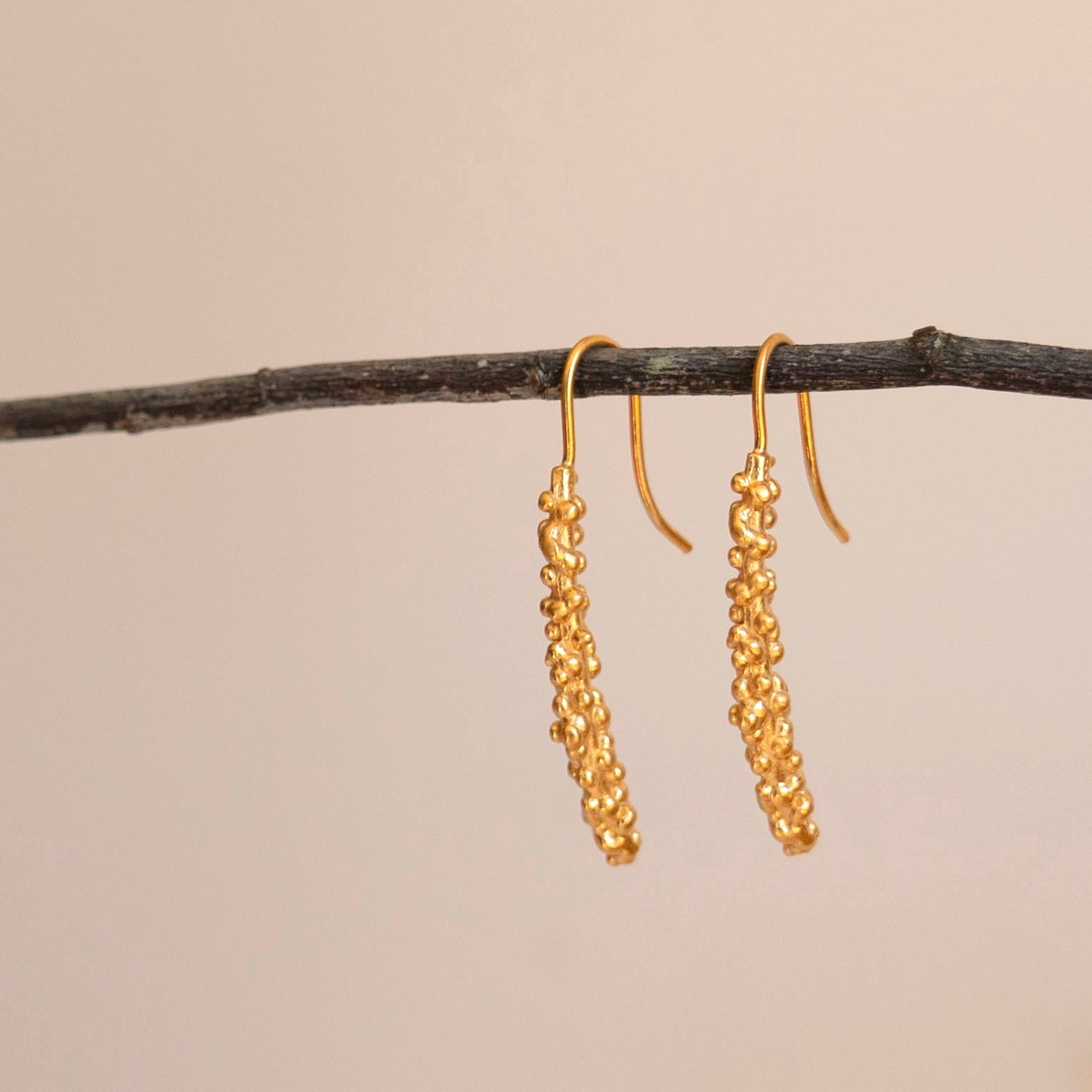 Gold millet stick drop earrings