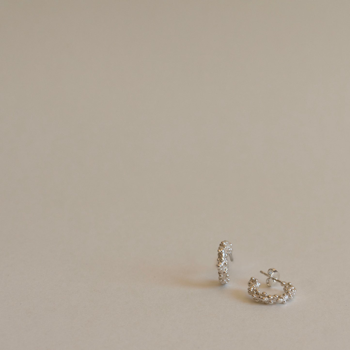 Silver millet seed hoop earrings
