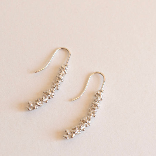 Silver millet stick drop earrings