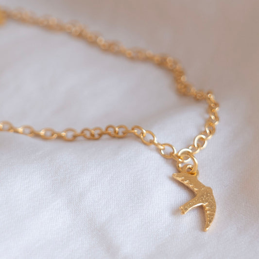 Gold swift charm bracelet