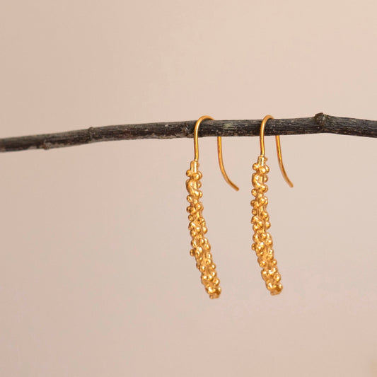 Gold millet stick drop earrings